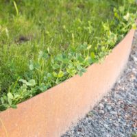 100mm x 3mm Corten steel garden edging strip showing the raw metallic finish before weathering.