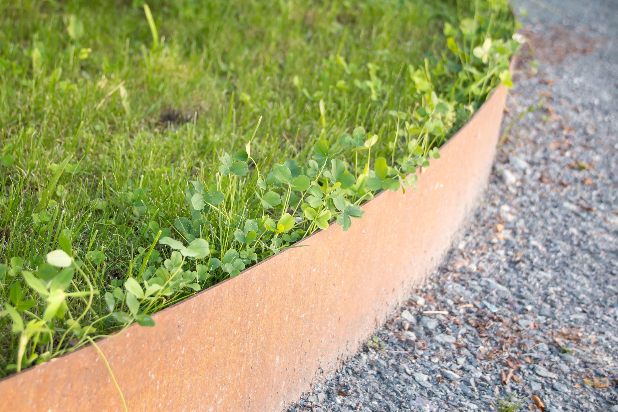 100mm x 3mm Corten steel garden edging strip showing the raw metallic finish before weathering.
